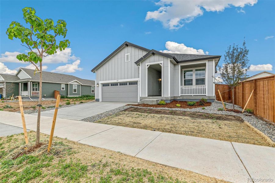 Front exterior of a new home in Farmlore, Brighton, CO, highlighting curb appeal (Image 23).