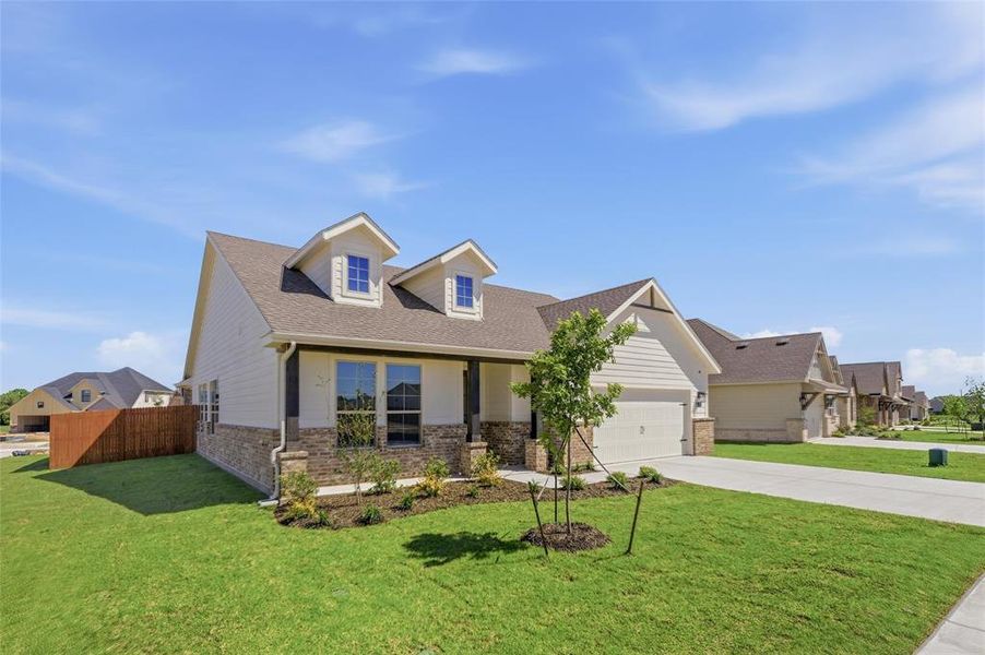 View of front of house featuring brick siding, an attached garage, concrete driveway, and a shingled roof