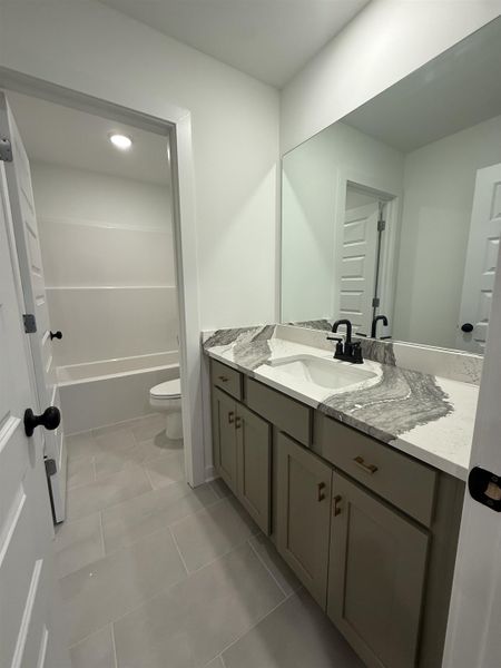 Full bathroom featuring vanity and light tile patterned floors