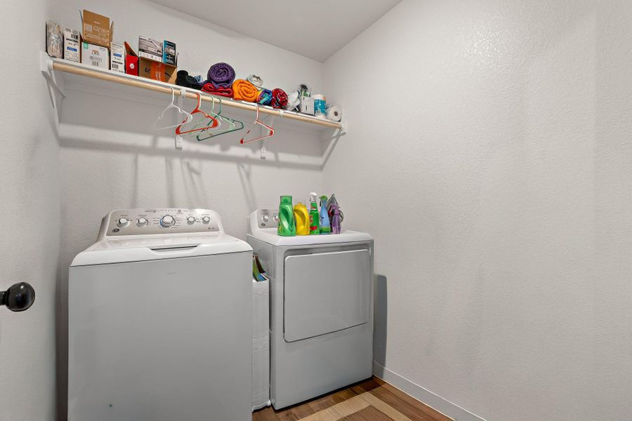 Dedicated laundry area with convenient overhead shelving. Dedicated laundry area with convenient overhead shelving.