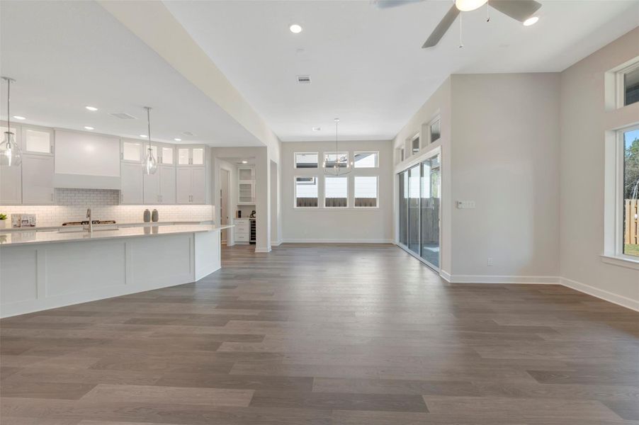 Spacious Dining room that offers sliding glass doors to rear covered patio and opens to Butlers pantry with wine fridge.