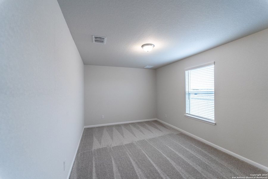 Spacious, unfurnished interior of a new home in The Woodlands at Medina Hills, Mico (Image 24).