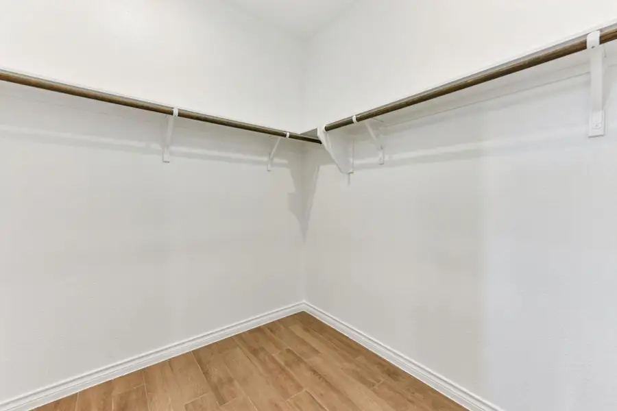 Spacious closet with light wood finished floors