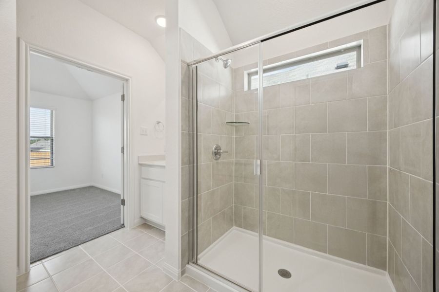 Primary Bathroom in the Redbud home plan by Trophy Signature Homes - REPRESENTATIVE PHOTO