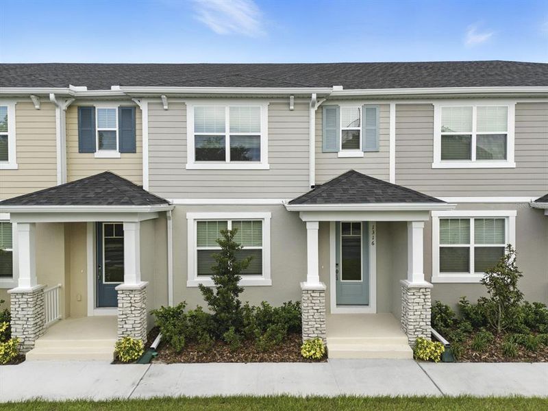 Front exterior of a new home in Hickory Grove, Winter Springs, FL, highlighting curb appeal (Image 1).
