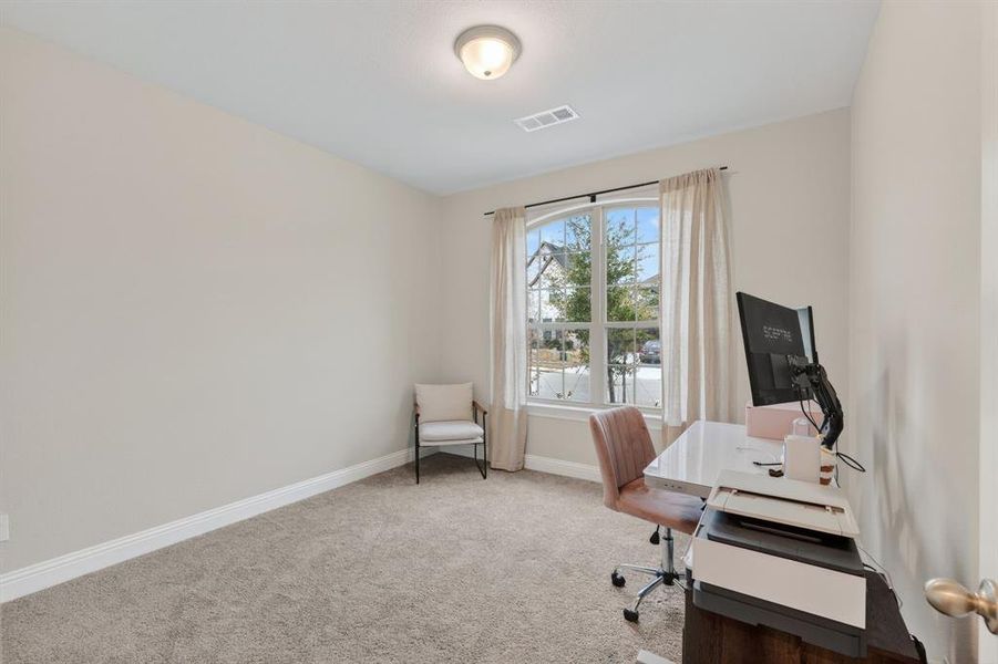 Office space featuring light carpet and baseboards Office space featuring light carpet and baseboards