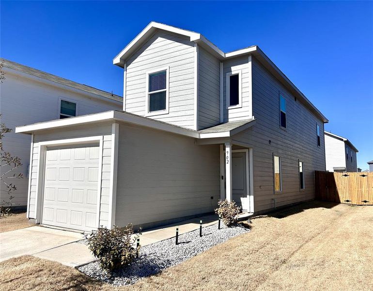 View of front of home featuring concrete driveway and a gate View of front of home featuring concrete driveway and a gate