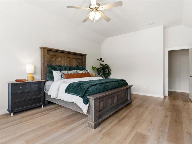 Private primary suite with spacious layout and peaceful views of the surrounding property.