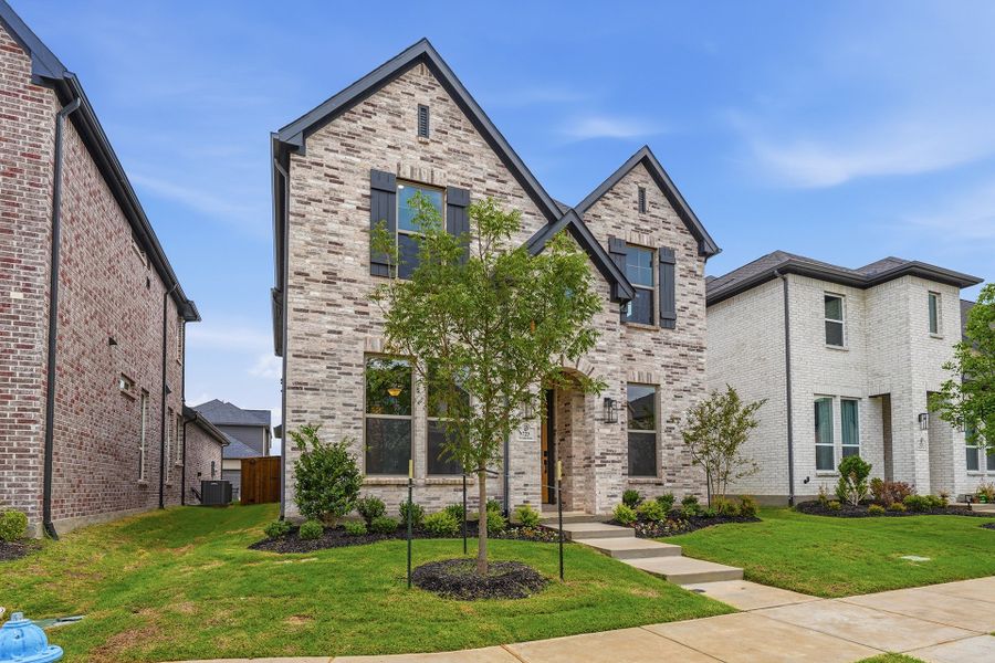Front exterior of a new home in Light Farms Brenham - 40' Lots, Celina, TX, highlighting curb appeal (Image 27). Front exterior of a new home in Light Farms Brenham - 40' Lots, Celina, TX, highlighting curb appeal (Image 27).