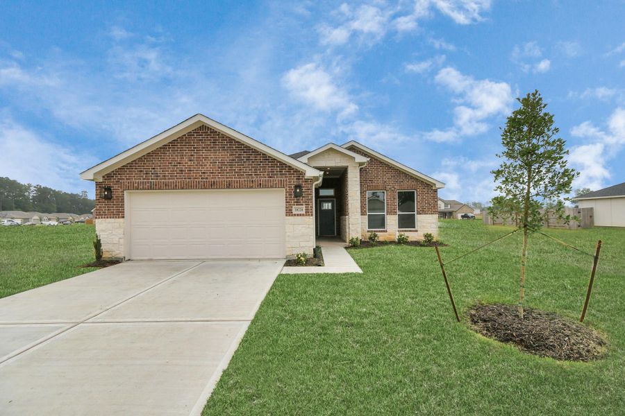 Front exterior of a new home in Grand Oaks Reserve, Cleveland, TX, highlighting curb appeal (Image 26). Front exterior of a new home in Grand Oaks Reserve, Cleveland, TX, highlighting curb appeal (Image 26).