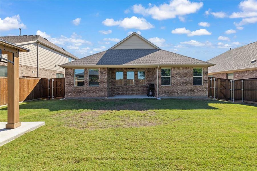 Back of property featuring a patio and a yard