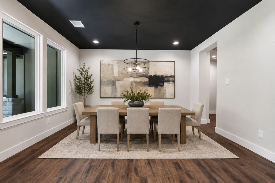 Digitally staged for inspiration, this elegant dining room features a modern chandelier, neutral tones, and stylish décor, creating a welcoming ambiance perfect for entertaining.