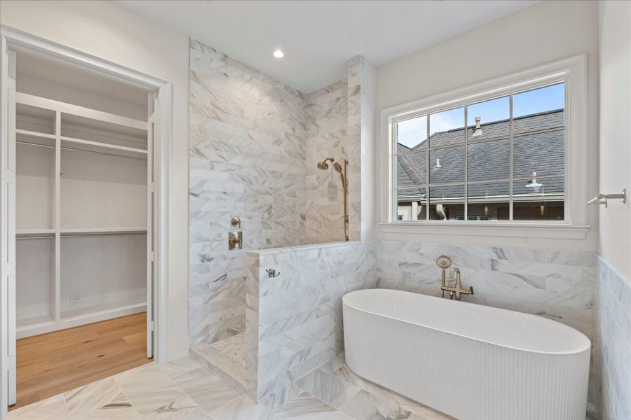 Primary with separate tub and stand up shower.