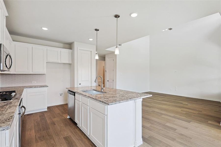 Kitchen featuring white cabinetry, light wood-type flooring, and stainless steel appliances