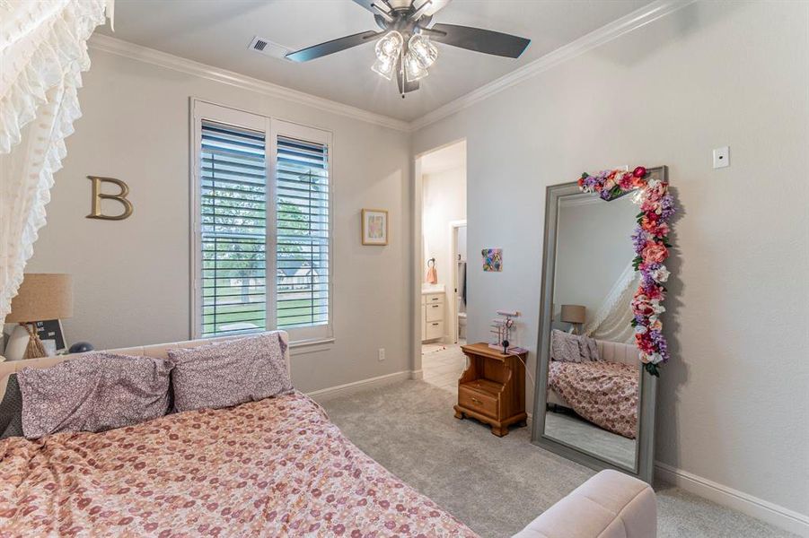 Bedroom featuring light carpet, crown molding, ceiling fan, and ensuite bathroom Bedroom featuring light carpet, crown molding, ceiling fan, and ensuite bathroom
