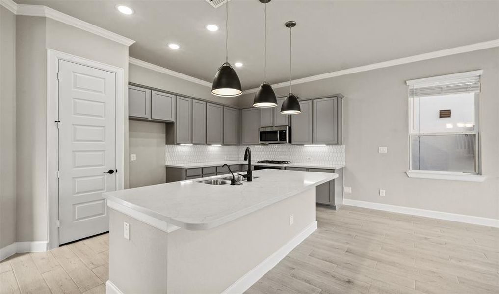 Elegant lighting in kitchen (*Photo not of actual home and used for illustration purposes only.)