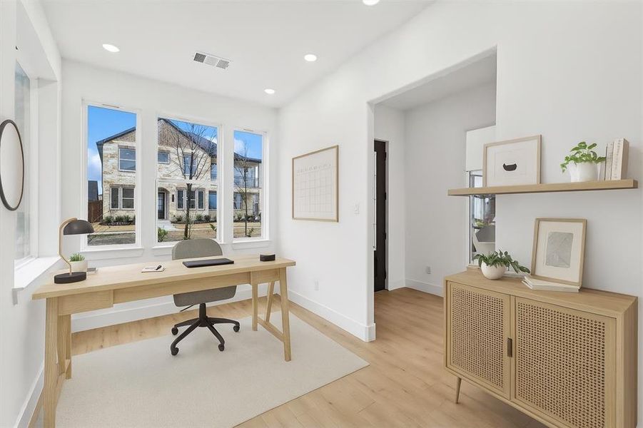 Office featuring light wood-style flooring and recessed lighting virtually staged
