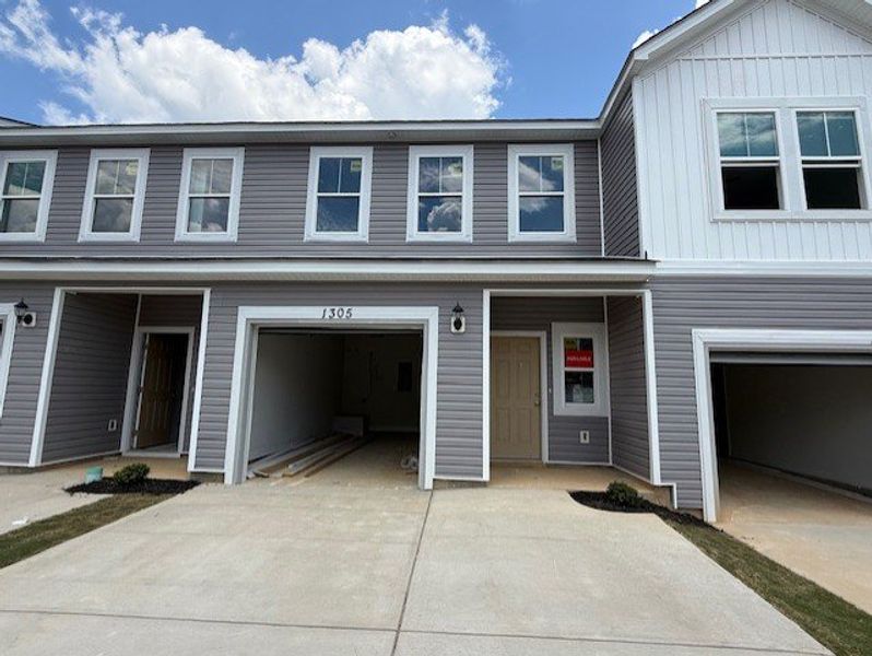 Front exterior of a new home in Caroleton Townhomes, Grovetown, GA, highlighting curb appeal (Image 1). Front exterior of a new home in Caroleton Townhomes, Grovetown, GA, highlighting curb appeal (Image 1).