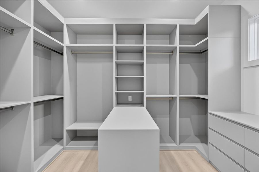 The primary walk-in closet provides exceptional storage with ample space to keep everything beautifully organized. The primary walk-in closet provides exceptional storage with ample space to keep everything beautifully organized.
