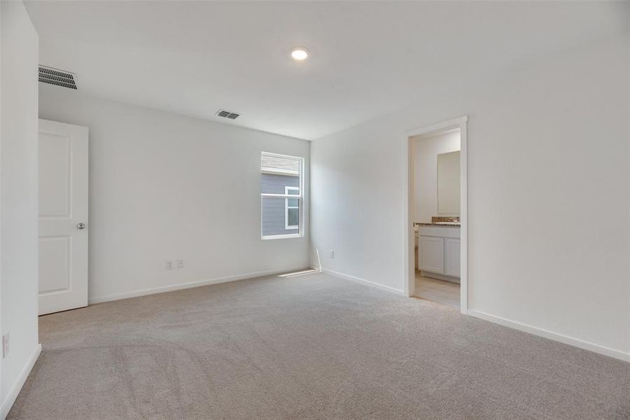 Spare room with light colored carpet