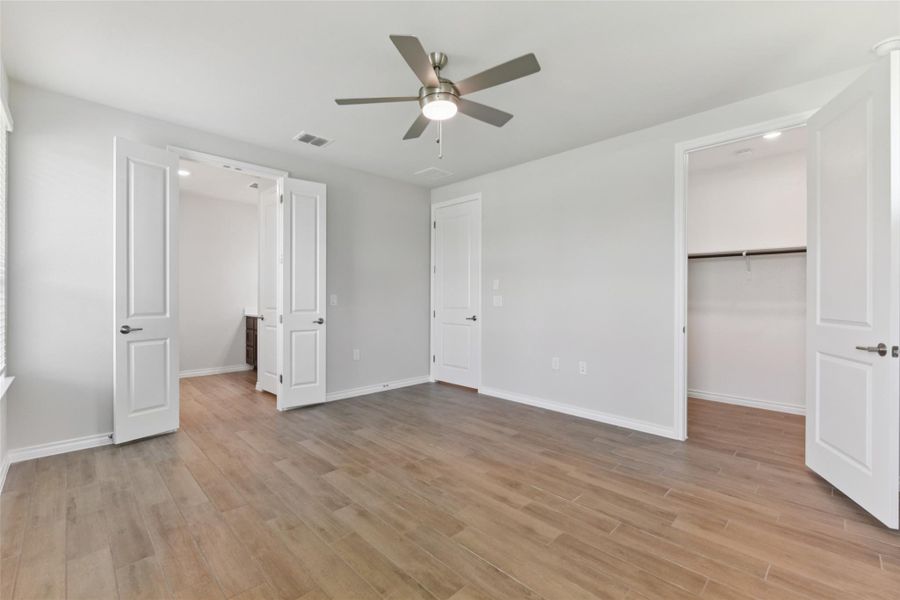 Unfurnished bedroom featuring a spacious closet, light wood-style flooring, a ceiling fan, and recessed lighting Unfurnished bedroom featuring a spacious closet, light wood-style flooring, a ceiling fan, and recessed lighting