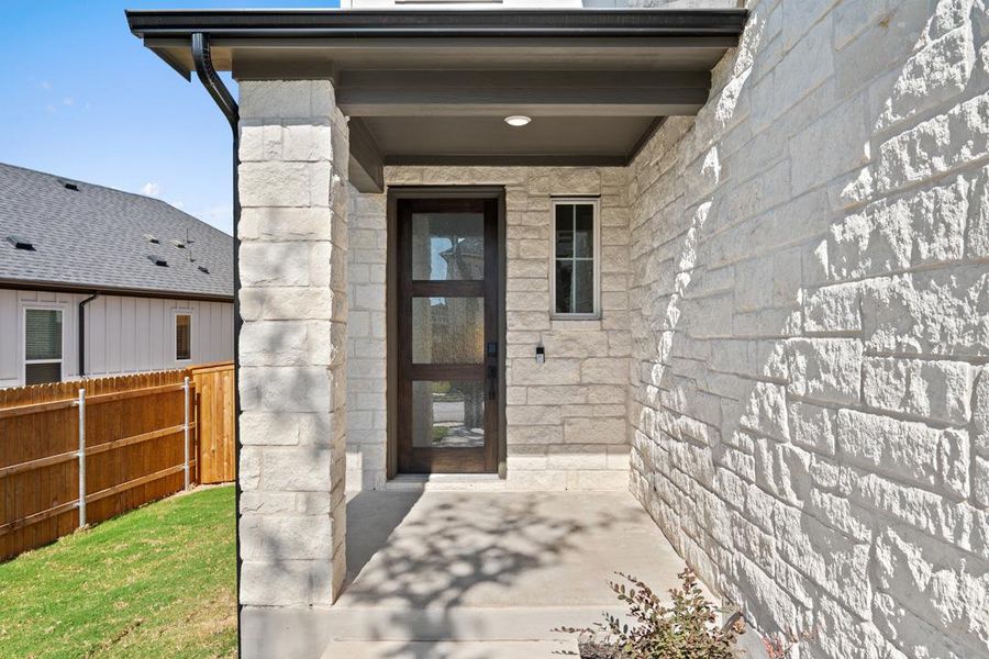 Exterior details and patio area of a home in Terrace Collection at Heritage, Dripping Springs (Image 17).