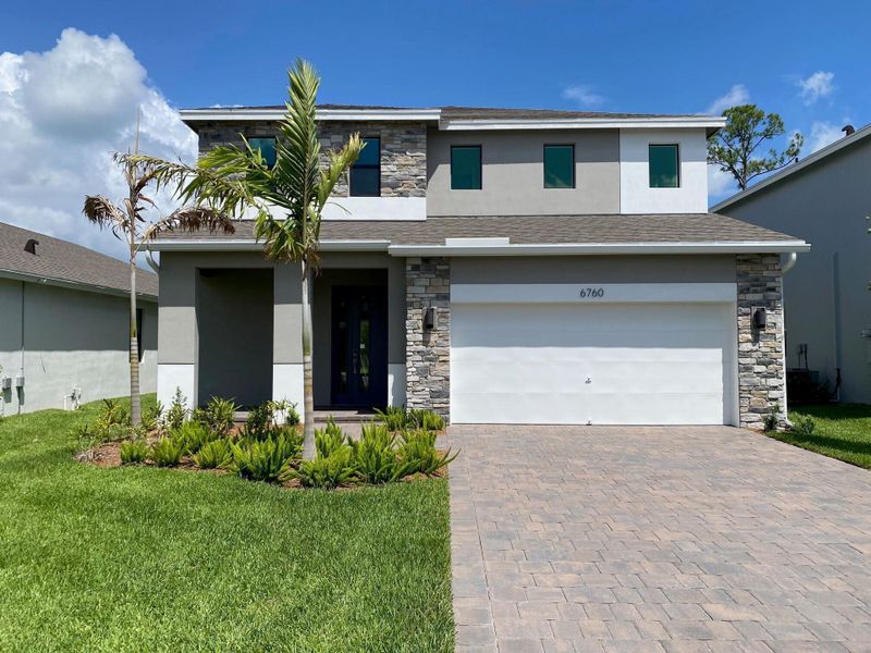 Front exterior of a new home in Preserves at Park Trace, Stuart, FL, highlighting curb appeal (Image 2). Front exterior of a new home in Preserves at Park Trace, Stuart, FL, highlighting curb appeal (Image 2).