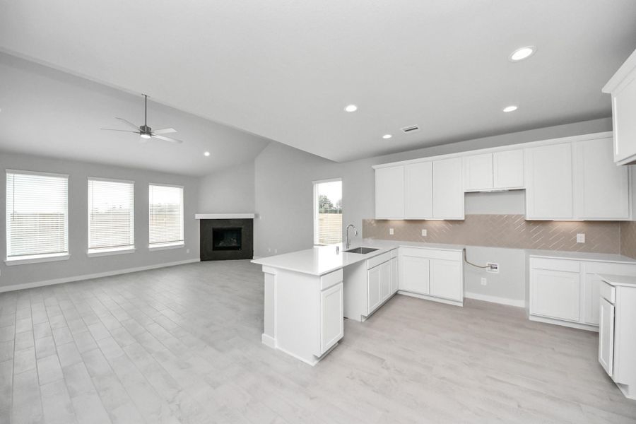 This kitchen is truly a chef's dream! This haven Boasts high ceilings, recessed lighting, stained wood cabinets, granite countertops, stainless steel appliances, a modern tile backsplash. All of this overlooks your expansive family room, creating a perfect space for culinary delights and family gatherings. Sample photo of completed home with similar floor plan. Actual colors and selections may vary. This kitchen is truly a chef's dream! This haven Boasts high ceilings, recessed lighting, stained wood cabinets, granite countertops, stainless steel appliances, a modern tile backsplash. All of this overlooks your expansive family room, creating a perfect space for culinary delights and family gatherings. Sample photo of completed home with similar floor plan. Actual colors and selections may vary.