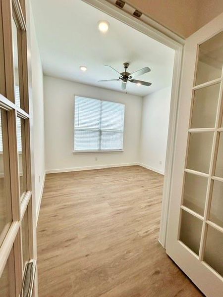 Room featuring wood-finish flooring, recessed lighting, and a ceiling fan Room featuring wood-finish flooring, recessed lighting, and a ceiling fan