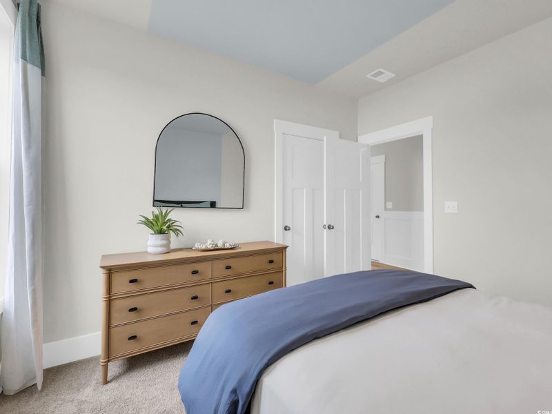 Bedroom with light colored carpet