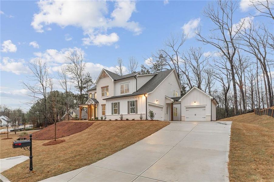 Front exterior of a new home in The Reserve at Knollwood, Canton, GA, highlighting curb appeal (Image 2). Front exterior of a new home in The Reserve at Knollwood, Canton, GA, highlighting curb appeal (Image 2).