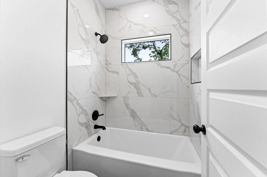 The other half of the shared bath features a tub and shower combination.