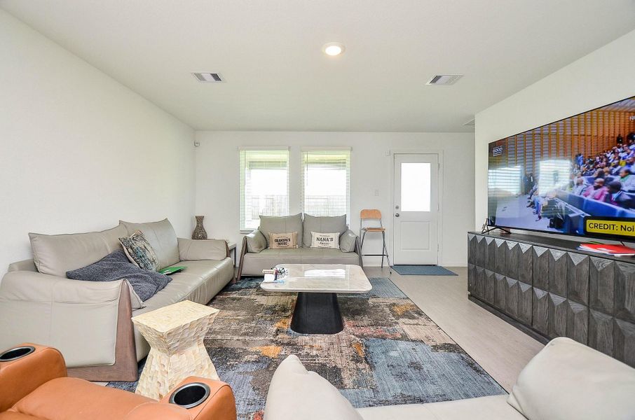 This two-story brick home features a modern design with a double garage and a well-maintained front yard. It's set against a clear blue sky and offers a spacious driveway and attractive landscaping.