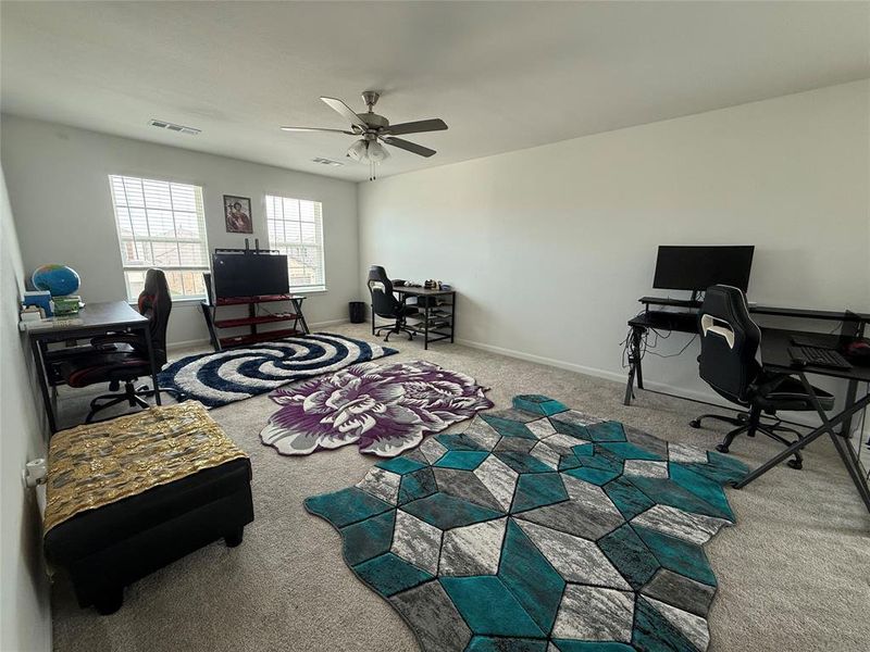 Spacious room featuring neutral carpet flooring and white walls