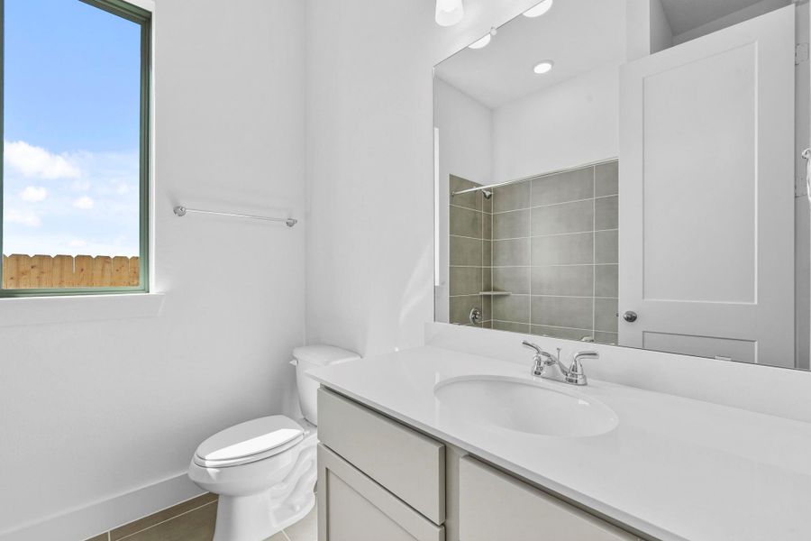 The secondary bathroom offers a clean, functional layout with modern fixtures and durable finishes designed for everyday use.