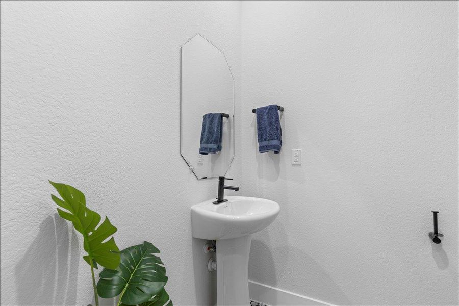 Half bath featuring a textured wall