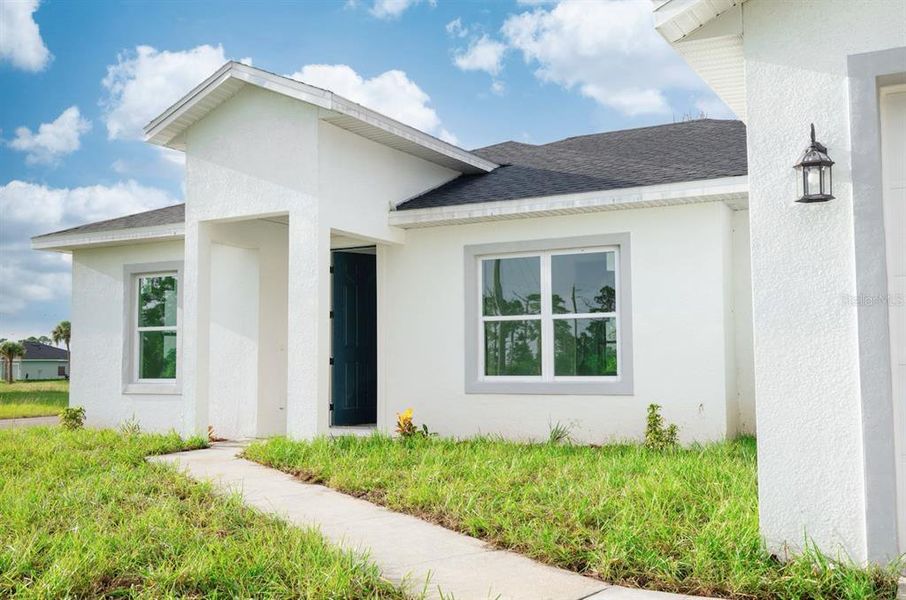 Front exterior of a new home in , Placida, FL, highlighting curb appeal (Image 26). Front exterior of a new home in , Placida, FL, highlighting curb appeal (Image 26).