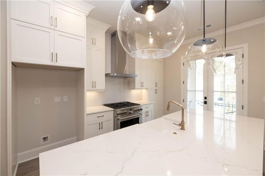 Oversized kitchen island:  Cambria- Inverness Frost Gloss - Waterfall design- extra storage in front cabinets.