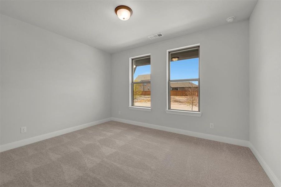 Carpeted empty room with baseboards