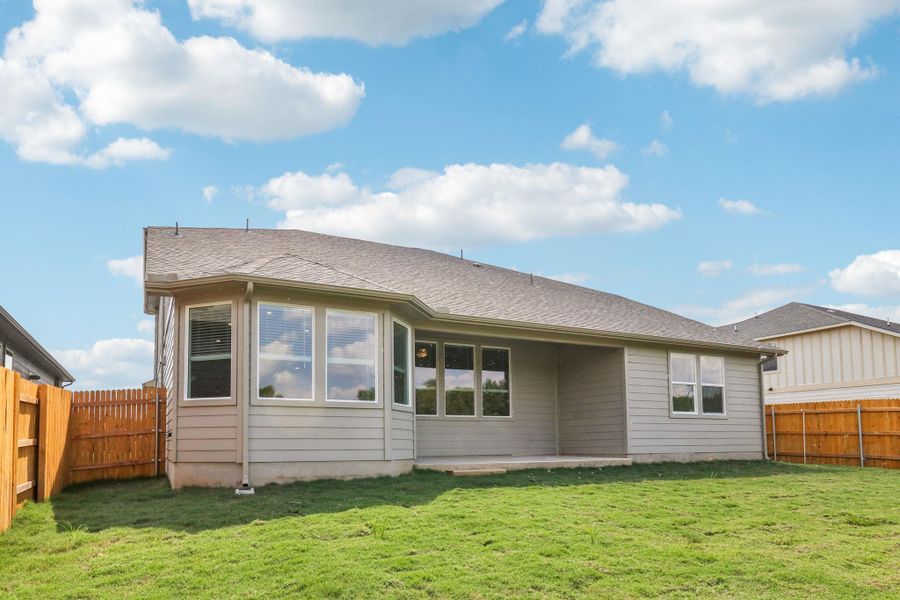 Back of house with a fenced backyard, a patio area, and a shingled roof Back of house with a fenced backyard, a patio area, and a shingled roof