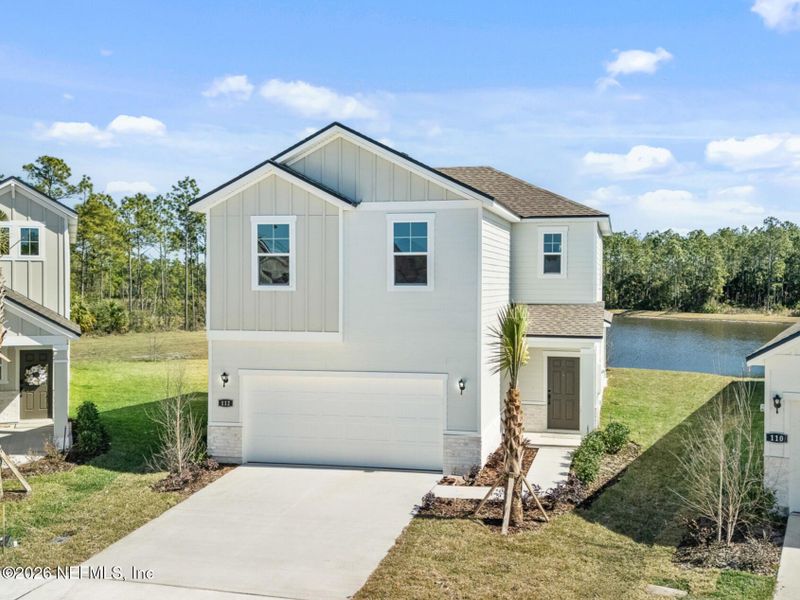 Front exterior of a new home in Seminole Palms, Palm Coast, FL, highlighting curb appeal (Image 18).