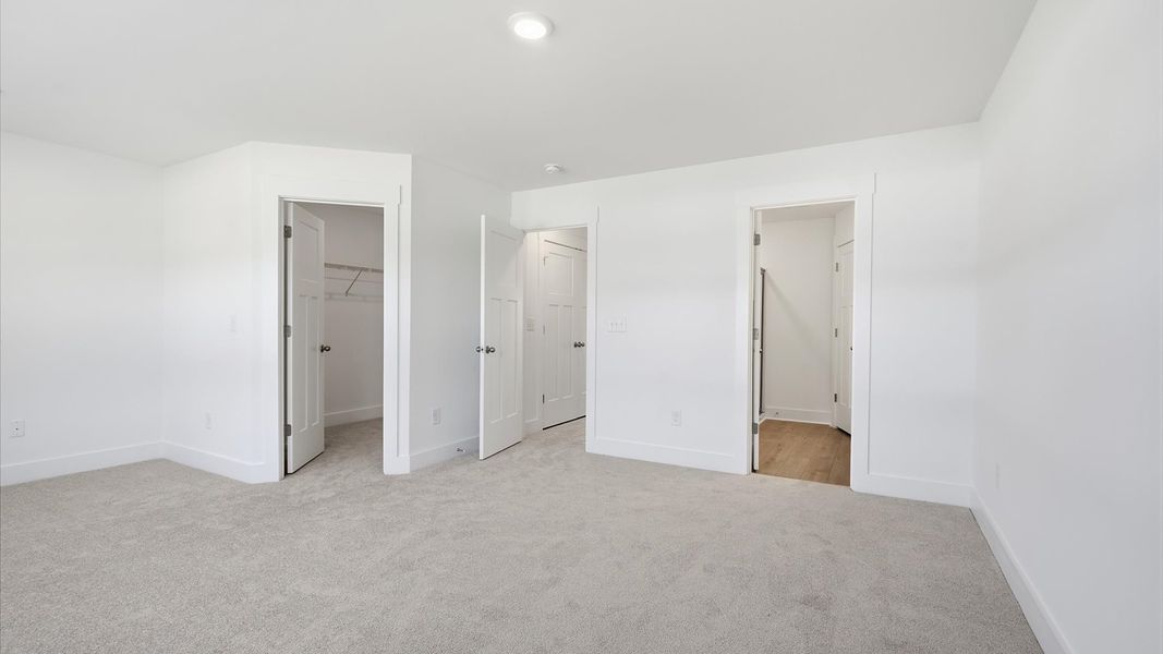 Eye-catching details and elegant finishes in the vibrant primary suite of this select home by DRB Homes