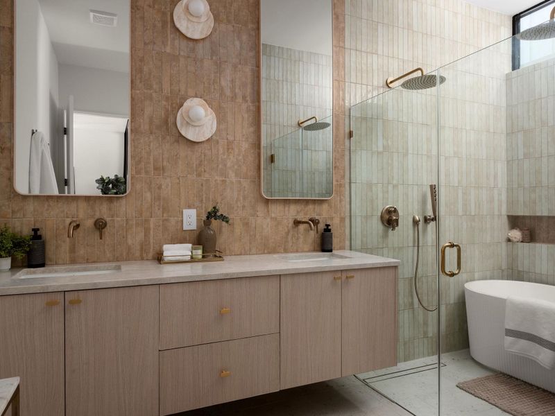 Double vanities and a glass-enclosed wet room define this contemporary bath space.