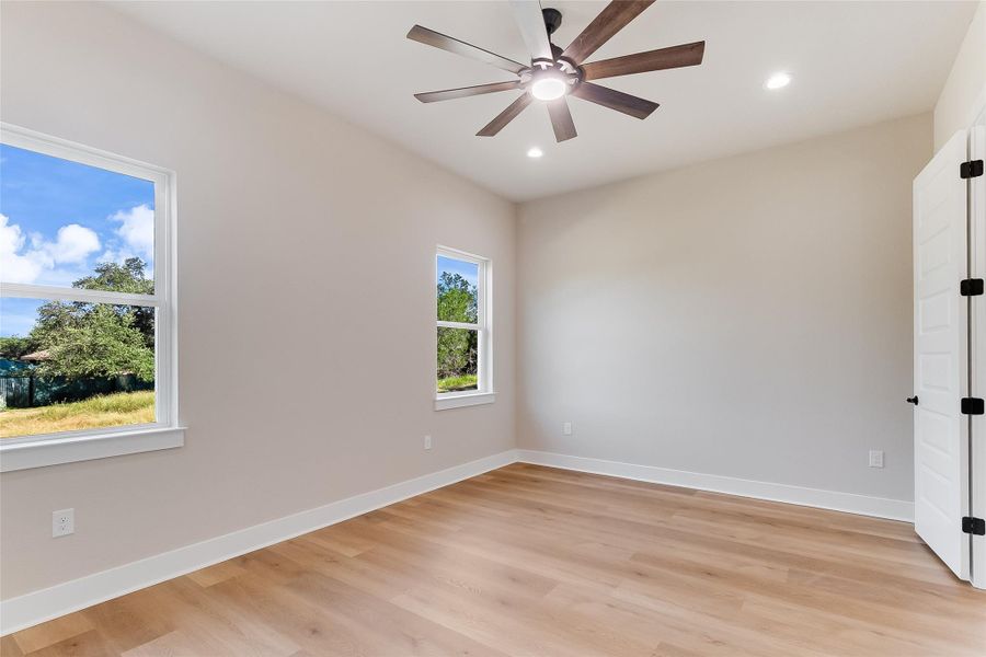 Empty room featuring light wood-style floors, recessed lighting, and a ceiling fan Empty room featuring light wood-style floors, recessed lighting, and a ceiling fan