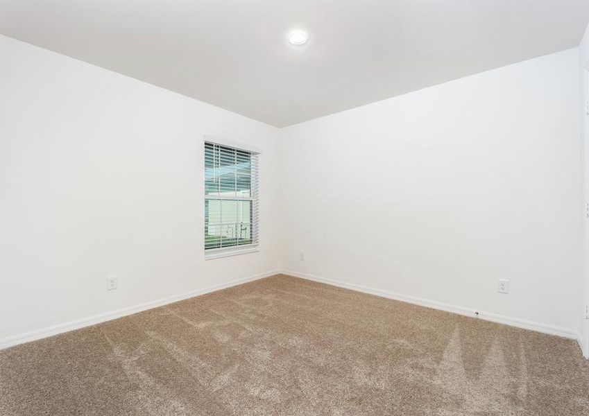 A secondary bedroom with carpet