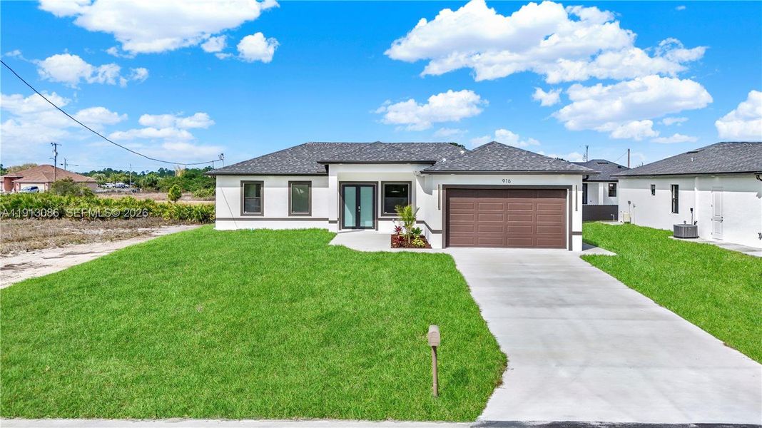 Front exterior of a new home in , Lehigh Acres, FL, highlighting curb appeal (Image 13).