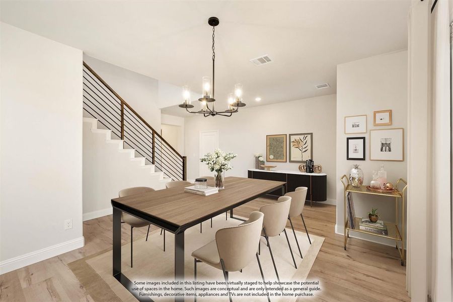 Dining room with wood table, six chairs, chandelier, and light hardwood floors near staircase