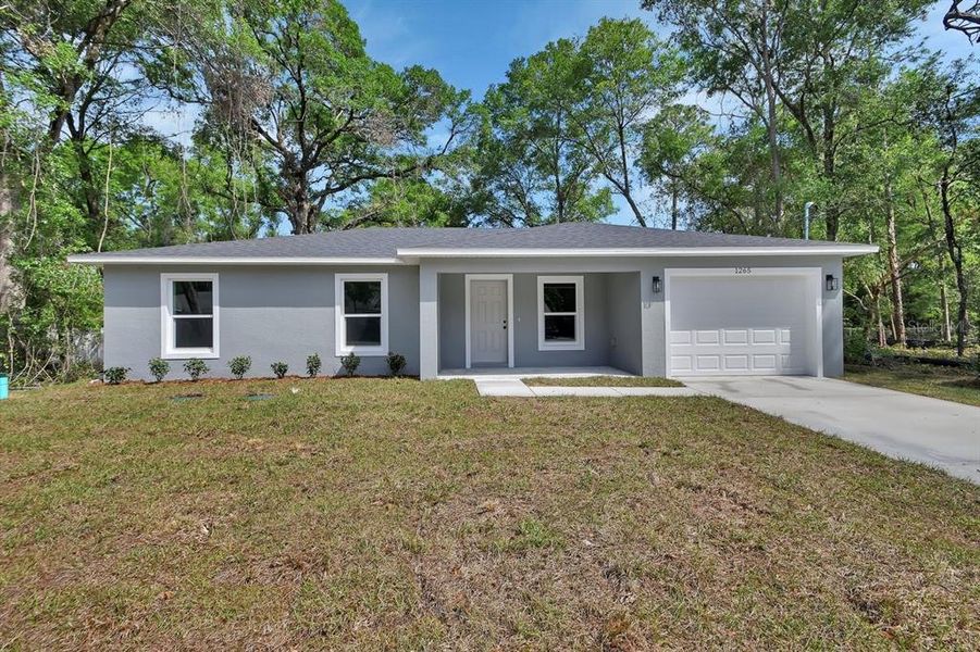 Front exterior of a new home in , Orange City, FL, highlighting curb appeal (Image 1). Front exterior of a new home in , Orange City, FL, highlighting curb appeal (Image 1).
