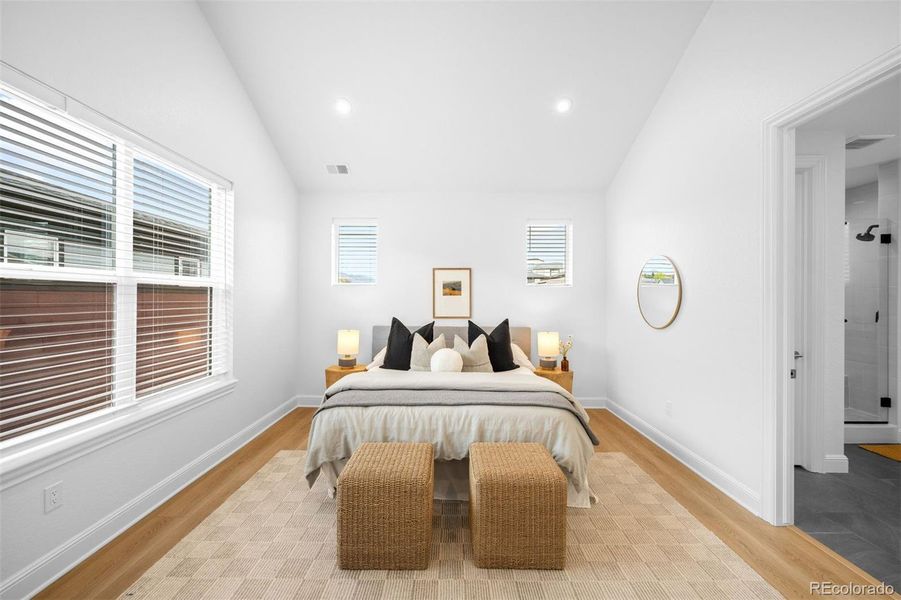 Vaulted ceiling design continues to primary bedroom