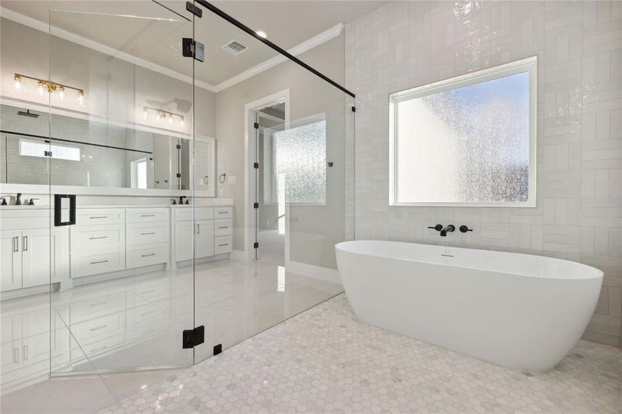 Bathroom with a wealth of natural light, plus walk in shower, and tile walls